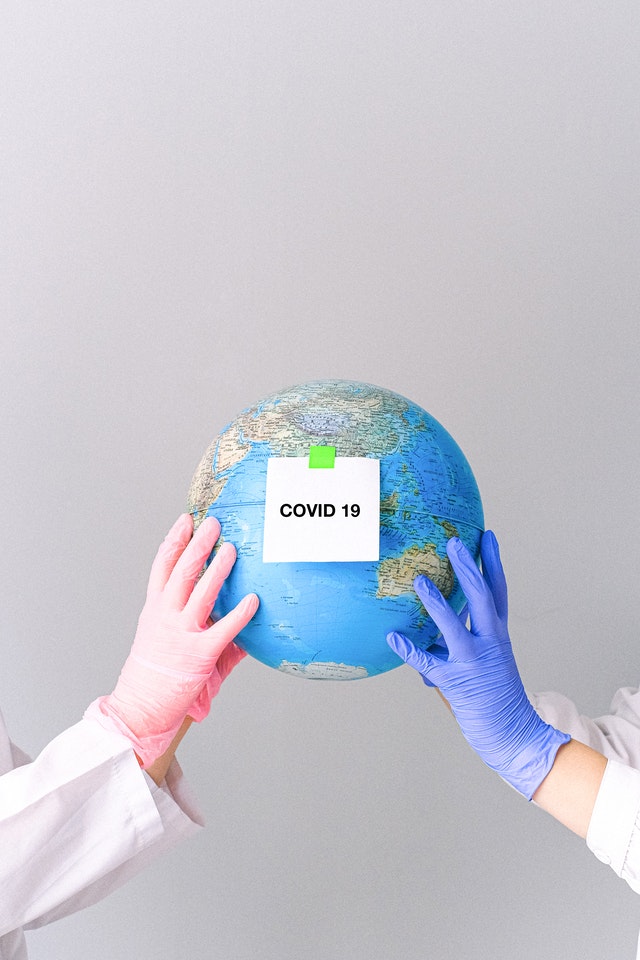 hands with latex gloves holding a globe 4167559